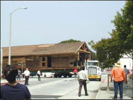 Photograph of the semi-truck negotiating a tight turn while pulling the warehouse unit of Whittier's Southern Pacific depot