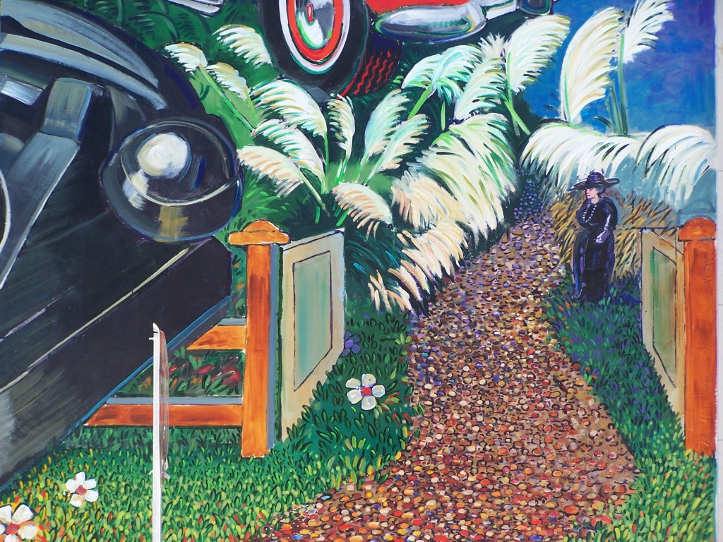 Finished mural: Photograph of the Harriet Russell Strong section of the mural facing Newlin Ave. Part of the telephone and Chevy car are also visible.