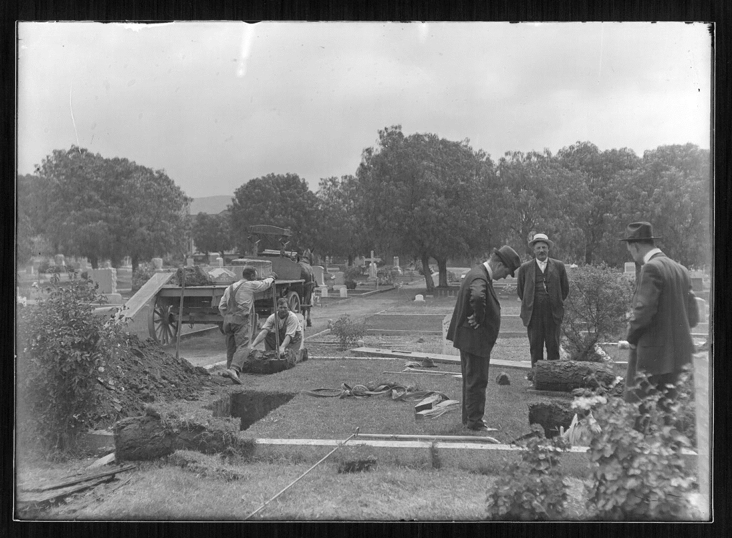 Old black and white photograph of a grave being dug at Broadway or Mount Olive cemeteries.