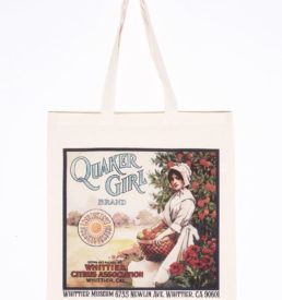 Photograph of a canvas tote-bag with the Quaker Girl Brand fruit crate label printed on the front of the bag.