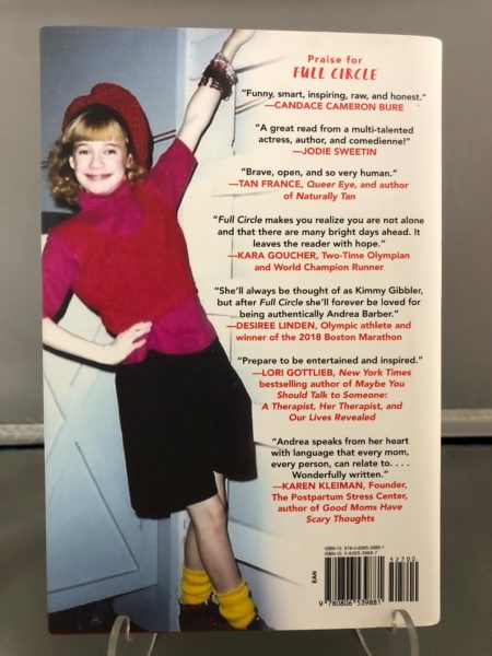 Photograph of the back of the slip cover for the book Full Circle. It shows a photograph of Andrea Barber from her child actress days and several blurbs praising the book.