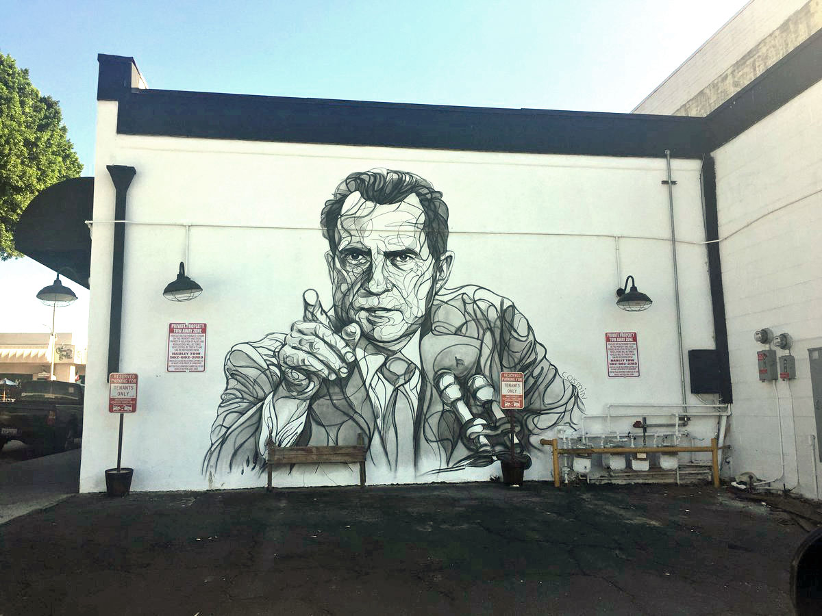 Photograph of the Richard Nixon mural that was on Bailey St.  The mural depicts Nixon pointing at a reporter.