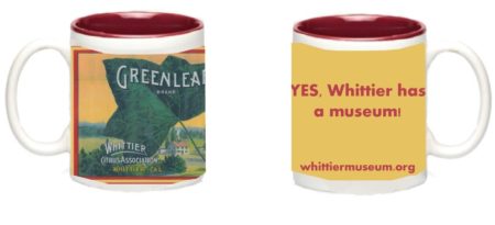 Photograph of the front and back of the Greenleaf mug. The front has the Greenleaf Brand fruit crate label graphic and the back has text "YES, Whittier has a museum! whittiermuseum.org