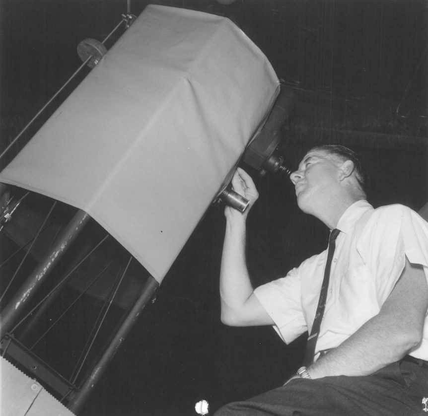 Photo of Paul Nemecek looking through the eyepiece of his telescope.