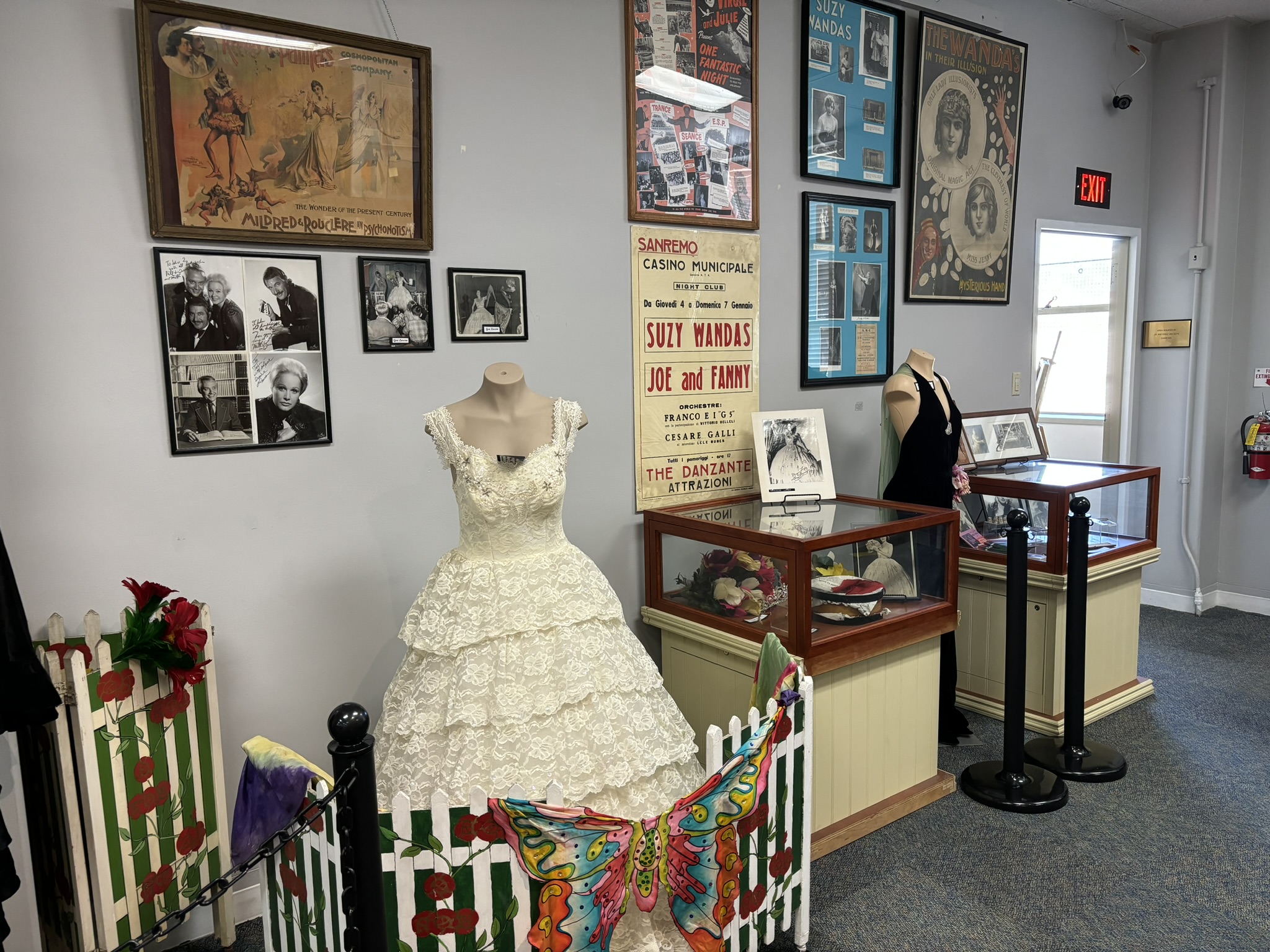 Photo of Magic Exhibit displaying dresses, props and posters of famous women magicians.