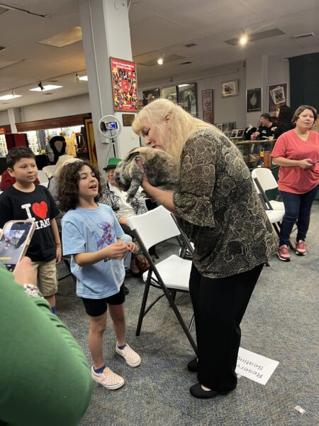 Magician, Kim, showing her magic bunny to children after performing her show.