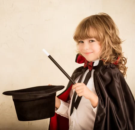 Promo photo of a little girl being a magician.