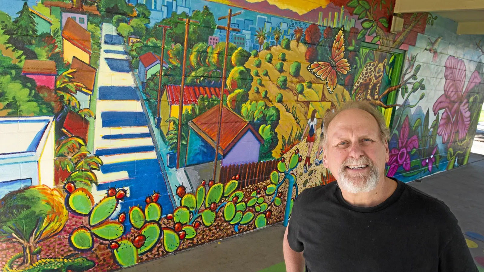 Dennis McGonagle Whittier artist in front of his mural at Rex Kennedy Park