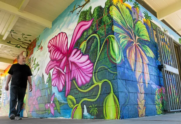 Dennis McGonagle Whittier artist walking by his mural at Rex Kennedy Park