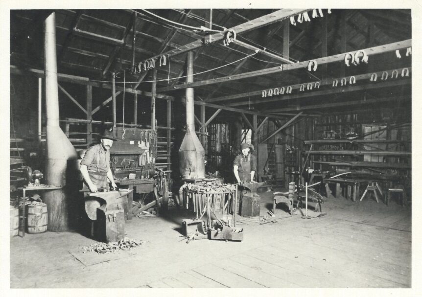 Rasmus Rasmussen and son Harry working in the blacksmith shop in 1910